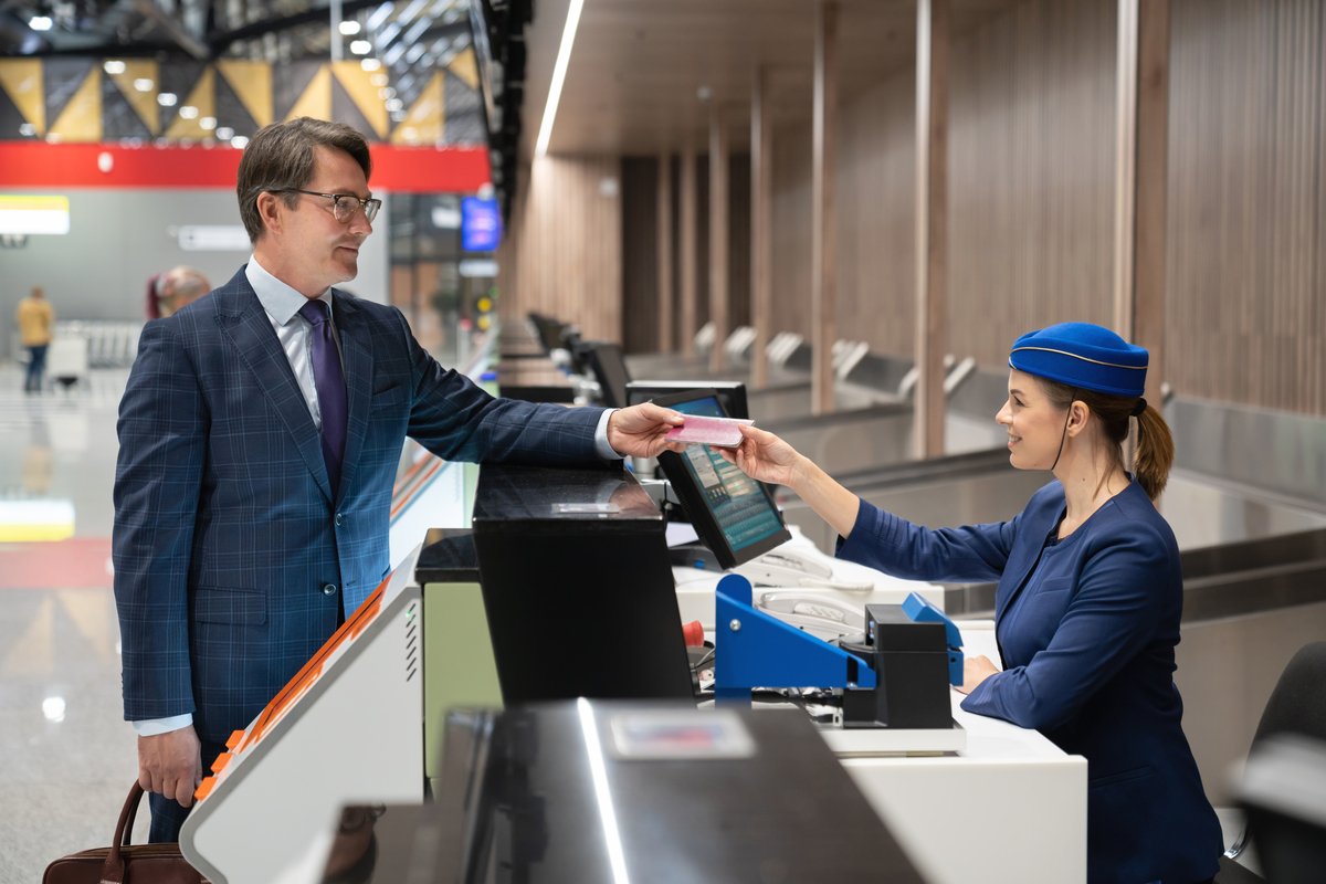 Business man traveling and doing the check-in at the airport