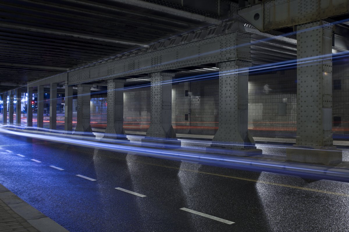 Urban road tunnel with light trails at night, Amsterdam
