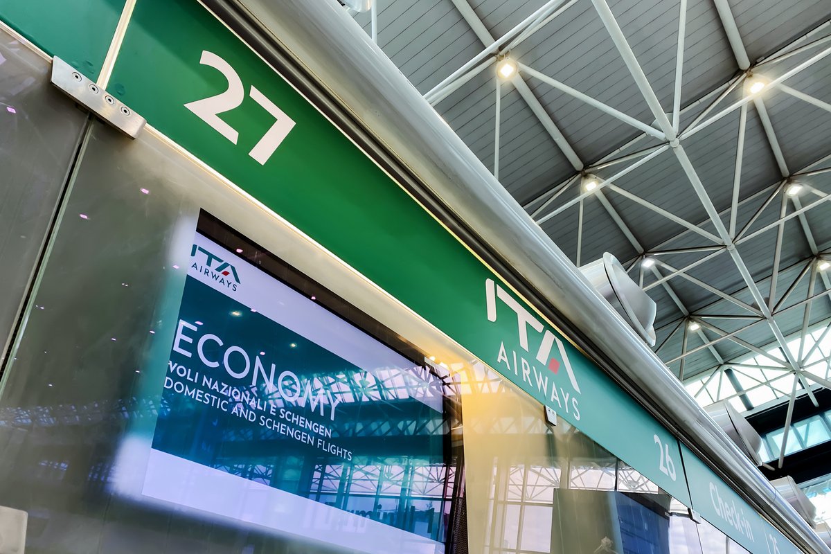Information panel of the ITA Airways check in desk inside the Rome airport