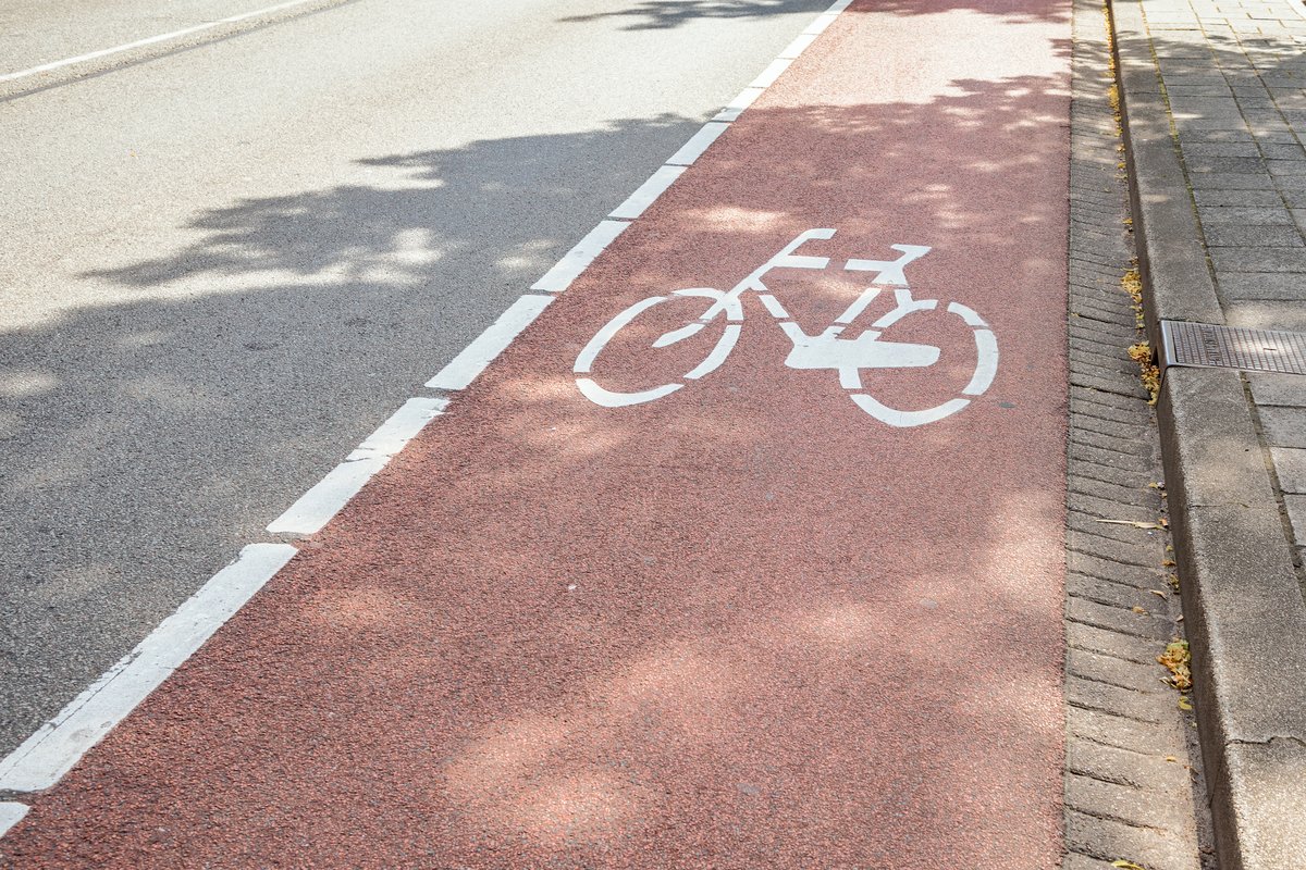 Red bicycle lane along a street in a city centre