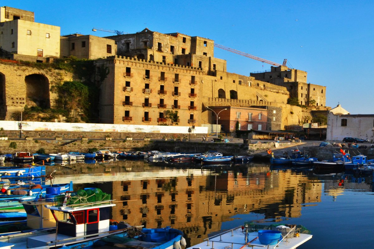 Naples, archaeological site reflected in the dock of Pozzuoli