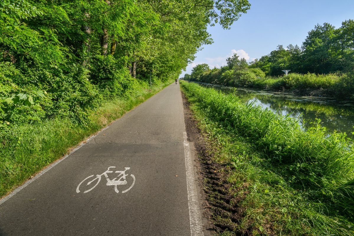 Empty cycling path along the Naviglio Pavese, canal which stretches for 30km from Pavia to Milan, Italy.